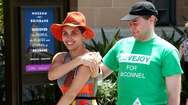 Greens candidate for McConnel Kirsten Lovejoy applying sunscreen before handing out How to Vote cards at Brisbane City Hall for pre poll voters. Photographer: Liam Kidston.