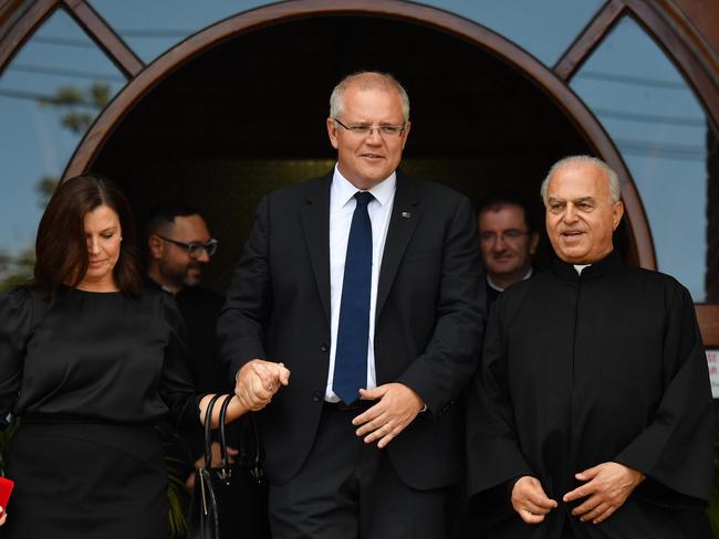 Prime Minister Scott Morrison, wife Jenny and Father Louis Ferkh leave after Good Friday Easter services at St Charbel's Catholic Maronite Church at Punchbowl in Sydney. Picture: AAP