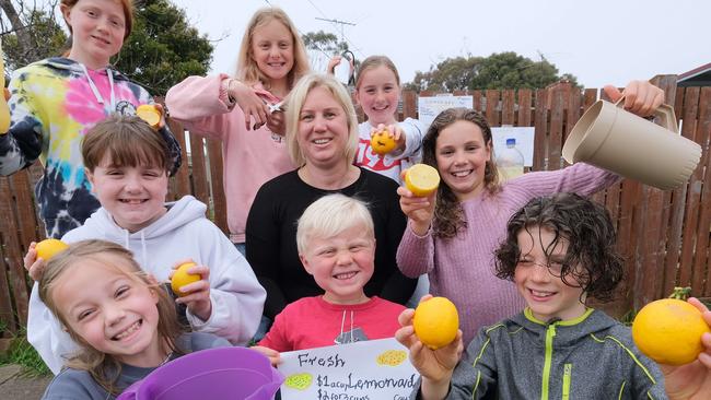 ICU nurse Rachel Swanson surrounded by the neighbourhood entrepreneurs. Clockwise from the back left: Piper 10, Tully 11, Nelly 8, Matilda 10, Paterson 7, Jimmy 5, Gypsy 9 and Rylie 11 Picture: Mark Wilson