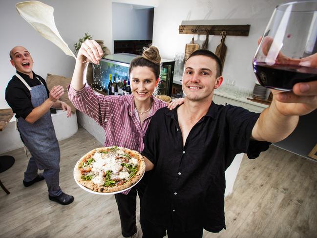 Zoe Johnstone and Tom McKay with chef Sergi flipping pizza at new pizzeria Spread in Camp Hill. Picture: Nigel Hallett