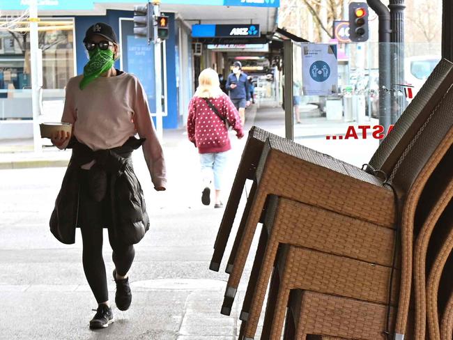 Chairs are stacked up outside a closed restaurant in Melbourne's Lygon Street on August 12, 2020, during a strict stage four lockdown of the city due to a COVID-19 coronavirus outbreak. - Australia's worst-hit state of Victoria appears to be curbing a virus outbreak after a week of tougher restrictions, authorities said on August 12, with new cases falling in recent days even as fatalities topped records. (Photo by William WEST / AFP)