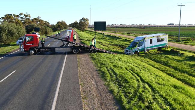 Preparations are made to remove the ambulance from the median strip on Port Wakefield Rd. Picture: Tait Schmaal