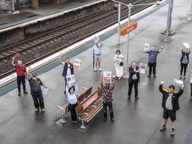 Campaigners holding the Blacktown Advocate at the station. Picture: Monique Harmer