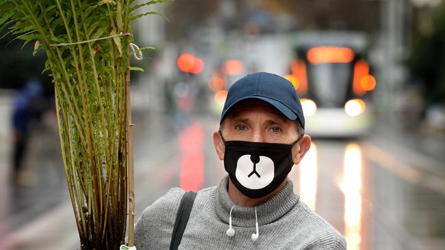 Forrister Jenot has started wearing a face mask in public, including when he's shopping in the Bourke Street Mall. Picture: Andrew Henshaw