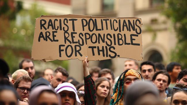 Protesters hold placards aloft as they march during the Stand Against Racism and Islamophobia march in Melbourne.