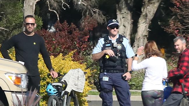 Celebrity trainer Commando Steve Willis (left) and his new girlfriend Harika Vancuylenberg with police in Kellyville on Sunday. Picture: David Swift