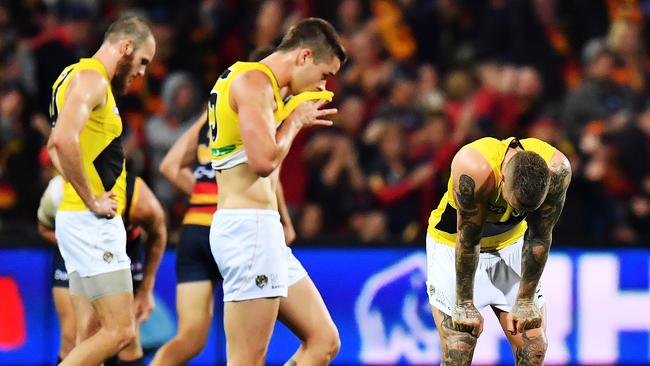 Dustin Martin of the Tigers (right) reacts after the final siren.