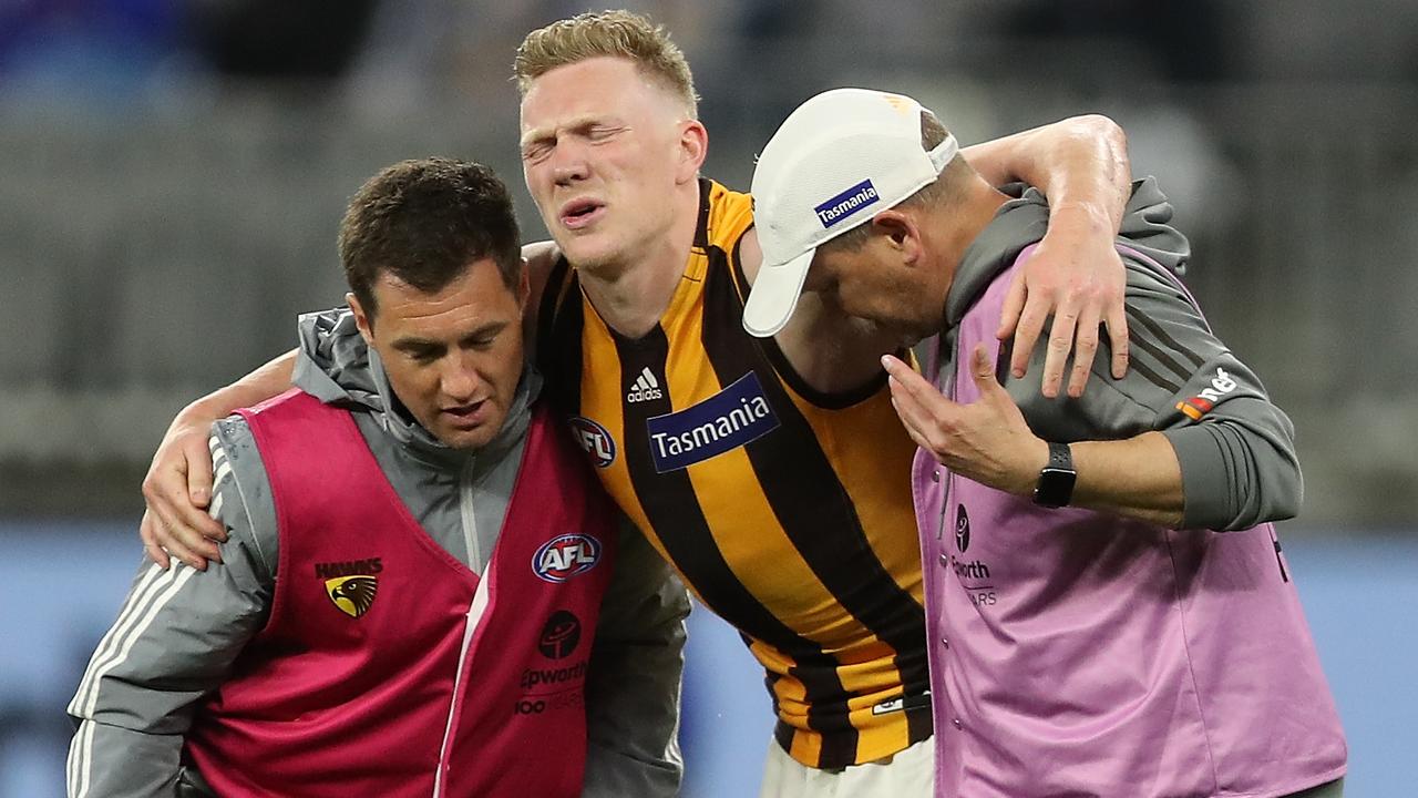 James Sicily of the Hawks is assisted from the field after injuring his knee. (Photo by Paul Kane/Getty Images)