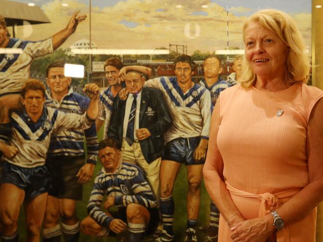 Lynne Anderson, the daughter of Canterbury patriarch Peter Moore poses next to a painting of her father after the Canterbury board elections, where it was announced she is set to take the place of Ray Dib as Chairman of the Bulldogs.