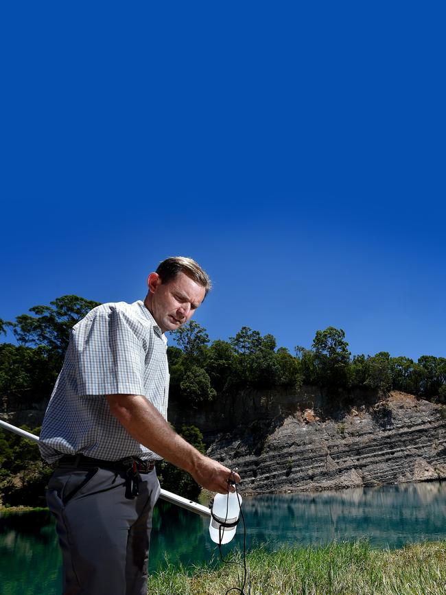 Southern Cross University laboratory director Graham Lancaster checks the Bexhill Quarry water pH to see whether the acidity levels were dangerous to humans.