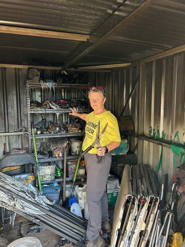 Karama Community Garden committee member Justine Glover looks at the wreckage of the group's shed after a wayward firework burned it down on Territory Day, 2024.