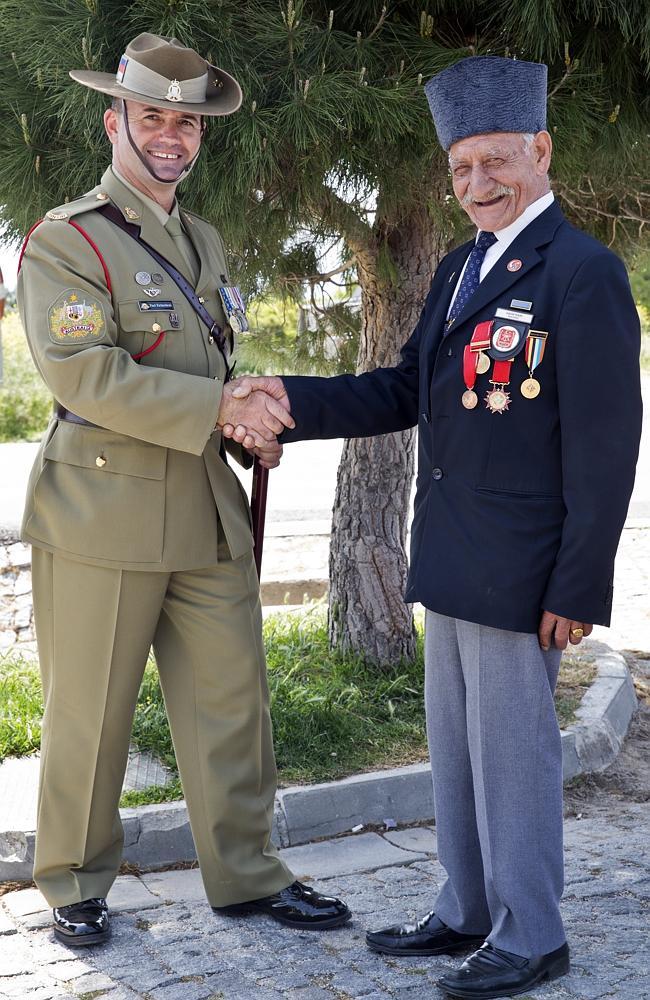 “We are all afriends” ... Commemorations Regimental Sergeant Major Warrant Officer Paul Richardson shakes hand with Turkish Sergeant Kadir Tekin, who fought in the Korean War. Picture: Ella Pellegrini