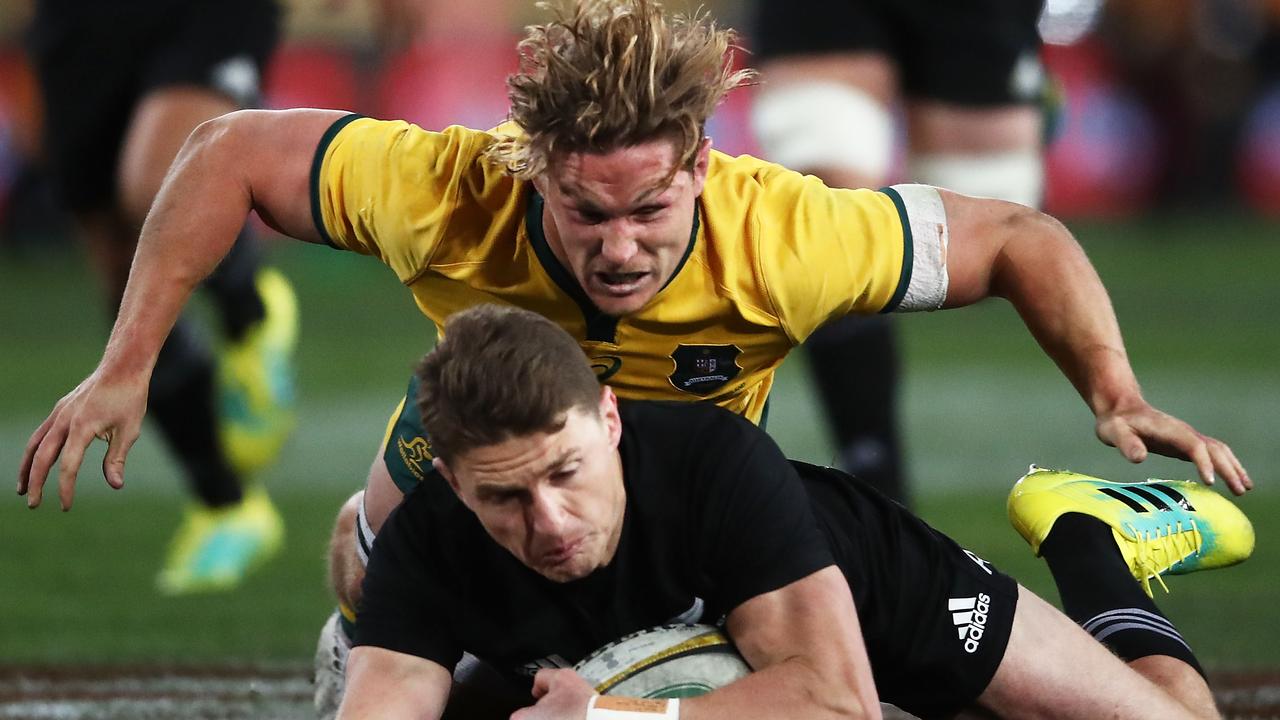 Beauden Barrett of the All Blacks is tackled by Michael Hooper of the Wallabies.