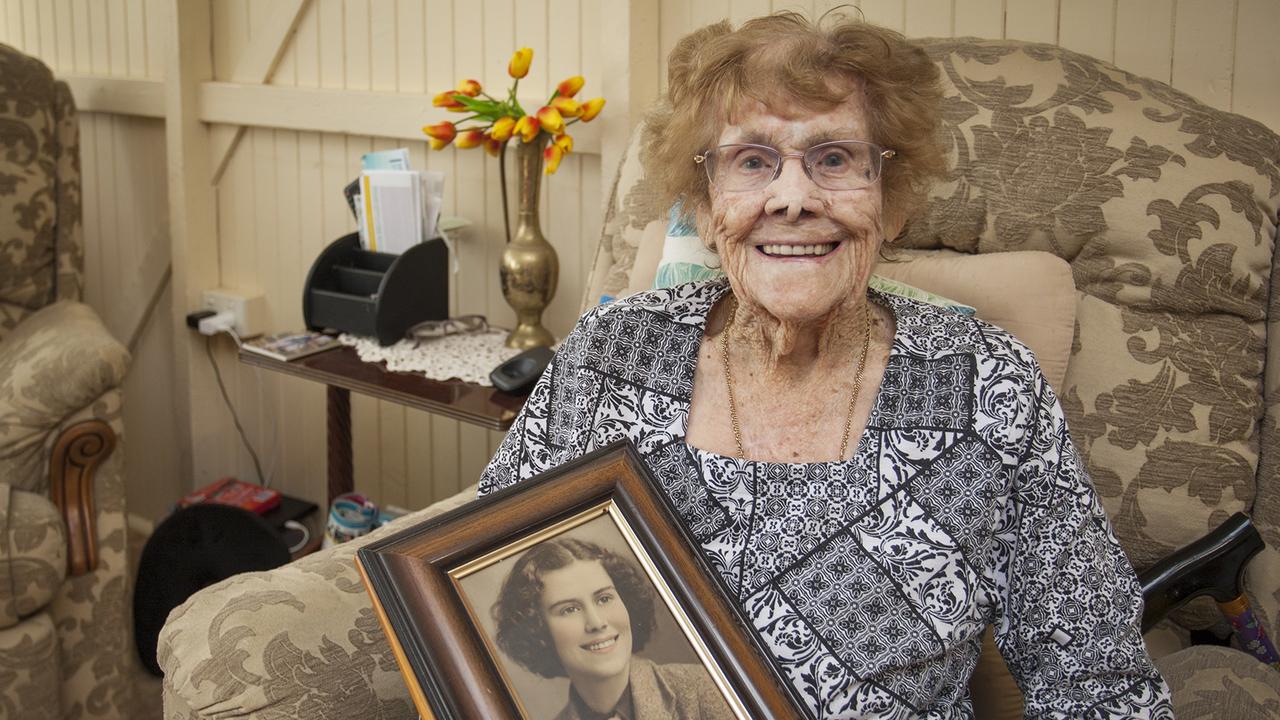 Cecilia Hynes of Maryborough, 102 years of age, holds a photograph of herself when she was aged 18 years.