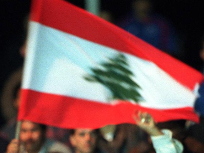 Heavy police presence at Belmore Stadium during Super League (SL) RL World Cup Challenge match Canterbury Bulldogs v Wigan 09/06/97 in bid to prevent repeat of 02/06/97 riot, fan with flag of Lebanon background.          New South Wales (NSW) / Fans / Flags / Police                Rugby League