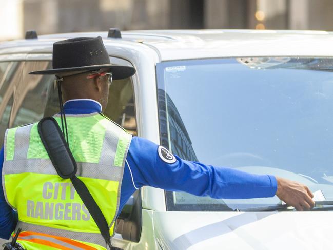 A city ranger issues a parking fine in Sydney’s CBD. Picture: NCA NewsWire/Jenny Evans