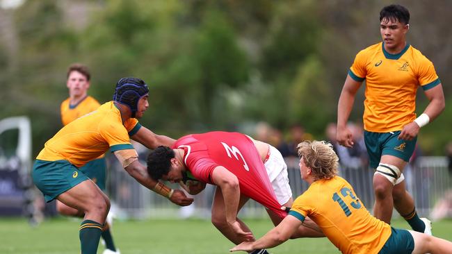 Taimiano Ahloo of the NZ Barbarians is tackled during the match between Australia U18s and New Zealand Barbarians at St Paul's Collegiate School in Hamilton.