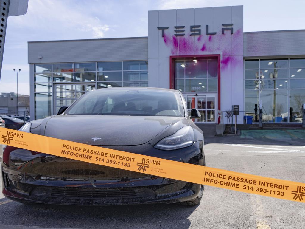 A Tesla dealership is vandalised with pink paint in Montreal, Canada. Tesla shares continue to fall amid recall of 46,000 cybertrucks. Picture: Christinne Muschi/The Canadian Press via AP