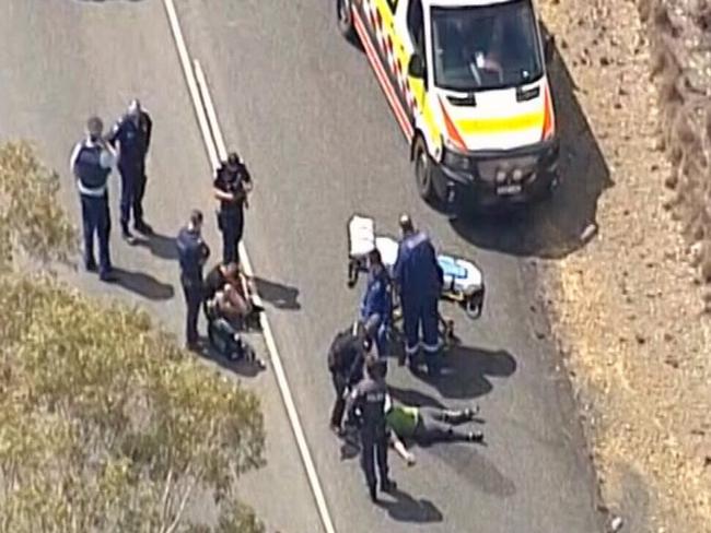 Police take a man and a woman into custody. Picture: 9 News