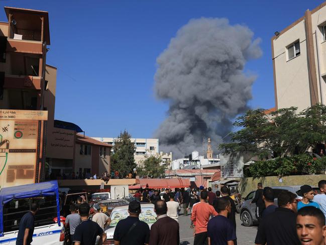 People watch as smoke and dust ascend following Israeli bombardment, in Khan Yunis in the southern Gaza Strip. Picture: AFP