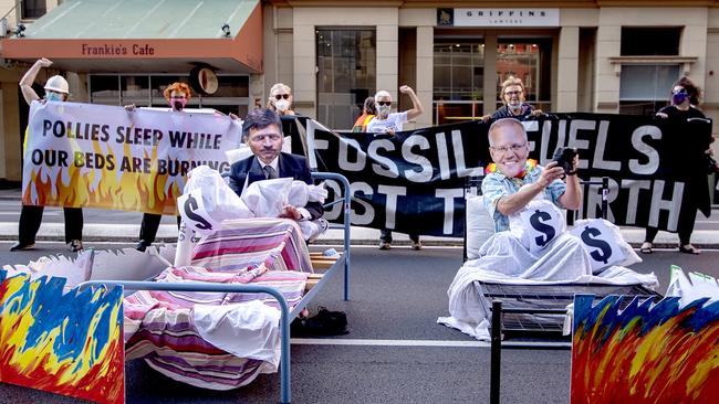 Extinction Rebellion members protest in front of the Santos building on Flinders Street. Picture: NCA NewsWire / Naomi Jellicoe