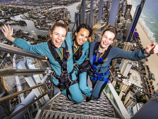 Skypoint Climb leaders Laiken French, Courtney Do and Piper Douglas are gearing up for an influx of tourists - but early bookings in hotels are modest. Picture: Nigel Hallett