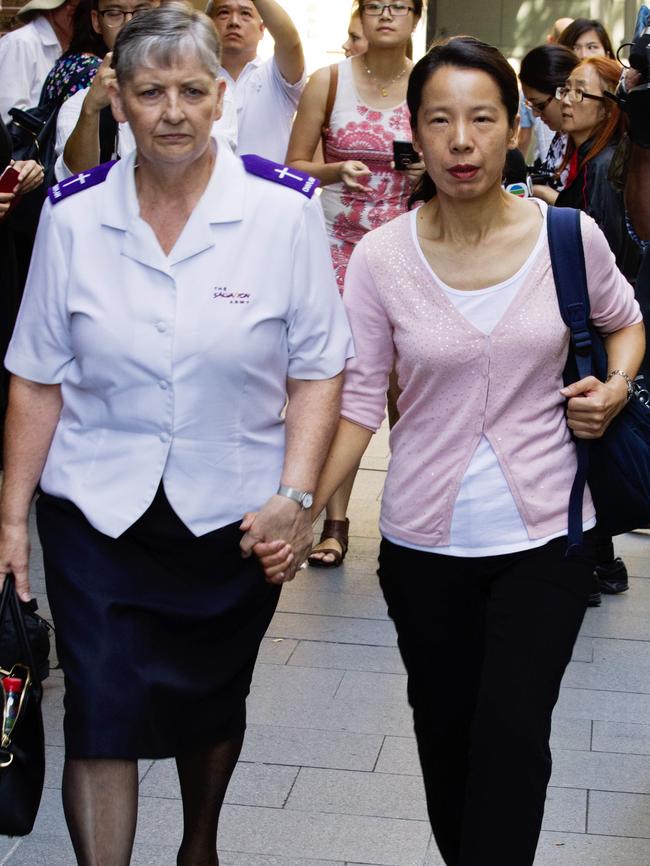 Robert Xie’s wife Kathy Lin, clutching the hand of a Salvation Army officer, still supports her husband. Picture: Jenny Evans