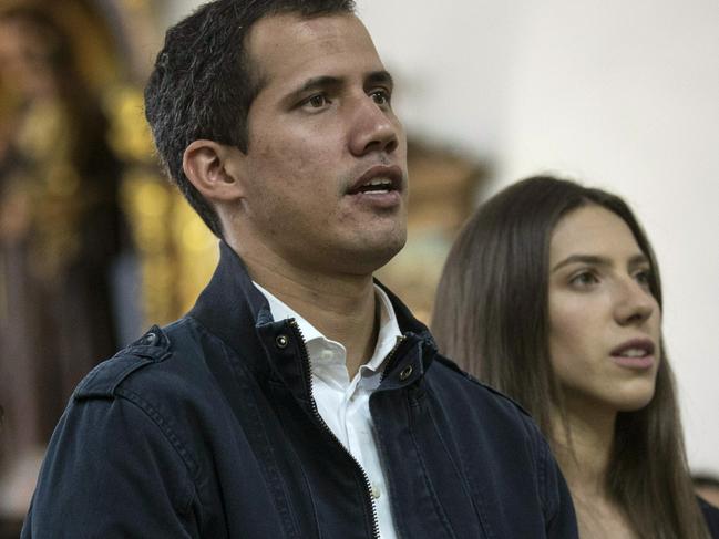 Opposition National Assembly President Juan Guaido, who declared himself interim president of Venezuela, prays next to his wife Fabiana Rosales, second from right, during Mass at a church in Caracas, Venezuela, Sunday, Jan. 27, 2019. Guaido says he is acting in accordance with two articles of the constitution that give the National Assembly president the right to hold power temporarily and call new elections. (AP Photo/Rodrigo Abd)