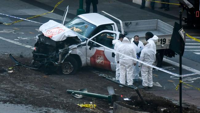 Investigators inspect the truck which ploughed into a pedestrian and bike path in Lower Manhattan.