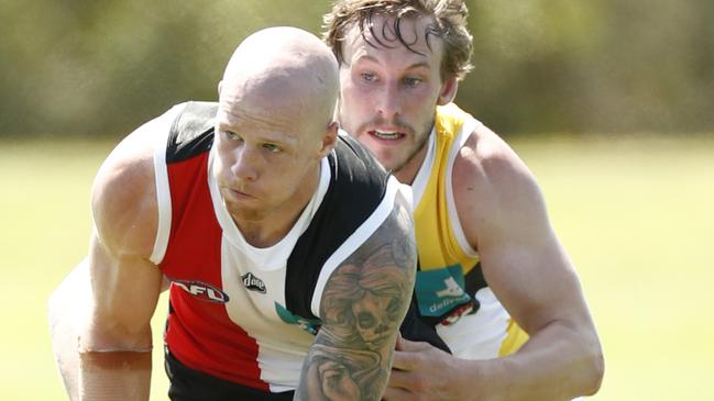 Zak Jones gathers possession under pressure from Jimmy Webster.