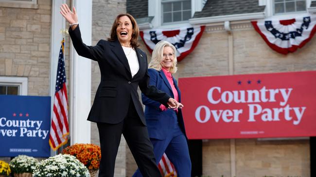 TOPSHOT - US Vice President and Democratic presidential candidate Kamala Harris and former US Representative Liz Cheney (R) arrive for a campaign event at Ripon College in Ripon, Wisconsin, October 3, 2024. (Photo by KAMIL KRZACZYNSKI / AFP)