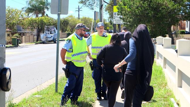 Police deal with parents trying to get to the school. Picture: Eliza Barr