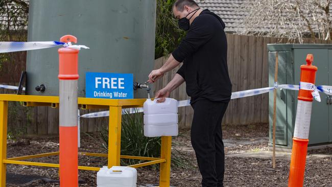 Residents collecting water at Griff Hunt Reserve in Croydon North. Picture: Sarah Matray