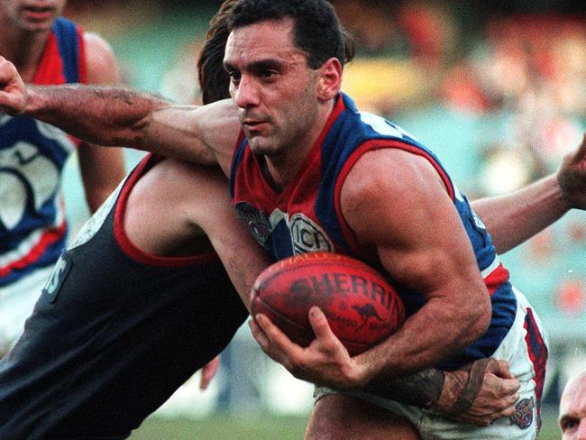 Tony Liberatore tries to shrug a tackle during a match against Melbourne.