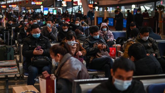 Wuhan railway station passengers await their train. Picture: AFP