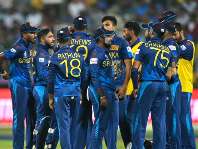 New Zealand's Rachin Ravindra (L) walks back to the pavilion after his dismissal during the 2023 ICC Men's Cricket World Cup one-day international (ODI) match between New Zealand and Sri Lanka at the M. Chinnaswamy Stadium in Bengaluru on November 9, 2023. (Photo by R.Satish BABU / AFP) / -- IMAGE RESTRICTED TO EDITORIAL USE - STRICTLY NO COMMERCIAL USE --