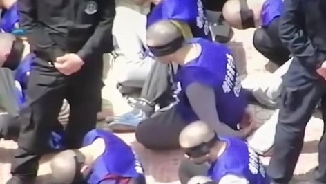 Blindfolded and shackled Uighurs in Xinjiang. Picture: YouTube