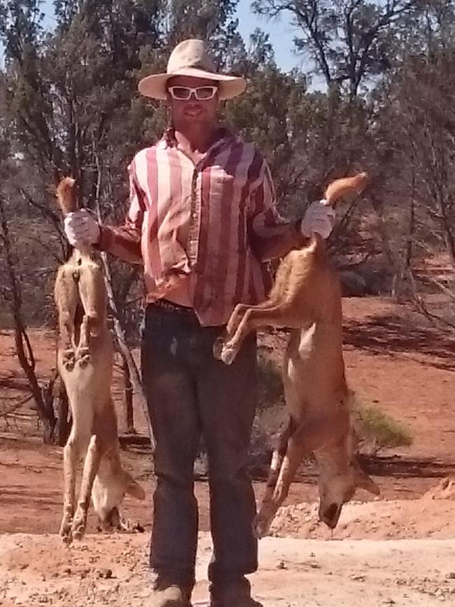 Pernatty Station overseer Joel Venables with dogs shot on his property.