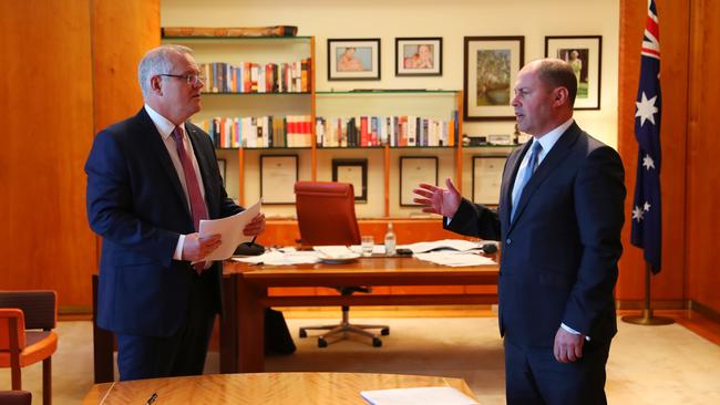 Prime Scott Morrison and Treasurer Josh Frydenberg work in the Prime Minister’s office in Canberra. Picture: Adam Taylor/PMO