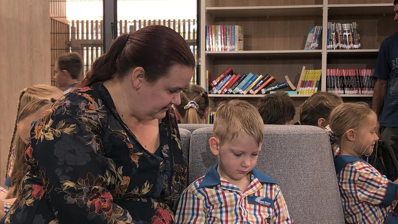 Mum Sarah Hutt reads to son Luca, 5, at his first day of school in prep at Queensland’s newest primary school Scenic Shores State School. Pictures; JUDITH KERR