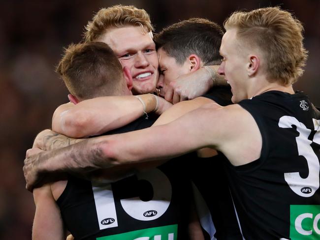 MELBOURNE, AUSTRALIA - SEPTEMBER 15: L-R Taylor Adams, Adam Treloar, Jack Crisp and Jaidyn Stephenson of the Magpies celebrate on the final siren during the 2018 AFL Second Semi Final match between the Collingwood Magpies and the GWS Giants at the Melbourne Cricket Ground on September 15, 2018 in Melbourne, Australia. (Photo by Adam Trafford/AFL Media/Getty Images)