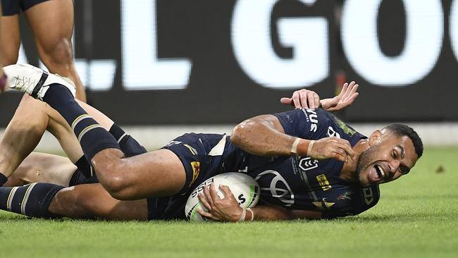 Justin O'Neil of the Cowboys scores a try during the round seven NRL match between the North Queensland Cowboys and the Canberra Raiders at QCB Stadium. (Photo by Ian Hitchcock/Getty Images)