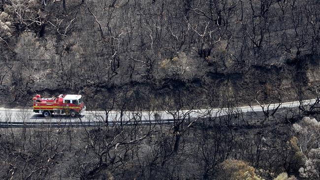 A fire truck drives on the fire damaged Great Ocean Road on Sunday, December 27, 2015, in Separation Creek, Victoria, Australia. Picture: Hamish Blair