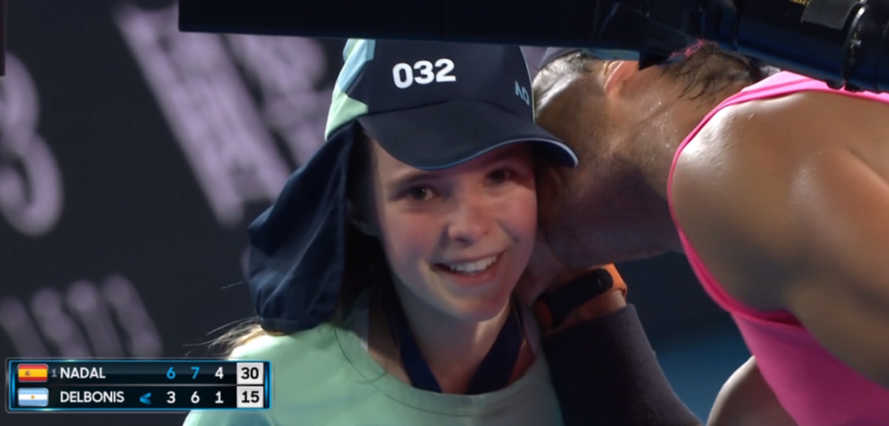 Rafael Nadal kisses a ball girl on the cheek after accidentally hitting her with an errant shot.