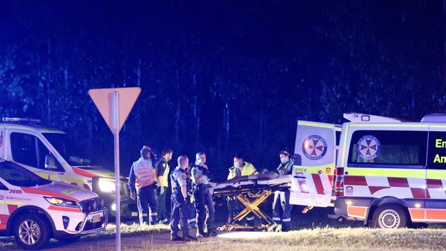 Paramedics treat a 17-year-old survivor at the crash scene. Picture: Steve Tyson