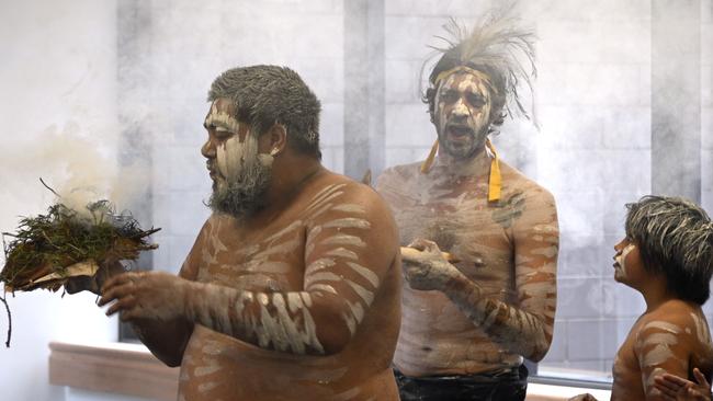 Joshua Brown leads the smoking ceremony at a health facility in Toowoomba.