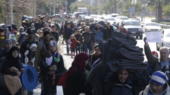 Refugees crowd an Athens street. Picture: BBC.