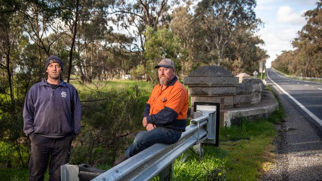 Local residents Gerard Hamill, and Steve Tobin at the bridge on the Hume Freeway which they say the beams cannot travel over. Picture: Jason Edwards