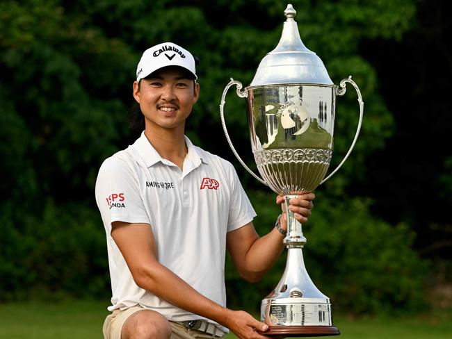 This handout photo taken and released by the Asian Tour on October 15, 2023 shows Min Woo Lee of Australia celebrating with the winner's trophy of the Macau Open at the Macau Golf and Country Club. (Photo by Paul LAKATOS / Asian Tour / AFP) / RESTRICTED TO EDITORIAL USE - MANDATORY CREDIT "AFP PHOTO / Asian Tour / Paul Lakatos" - NO MARKETING NO ADVERTISING CAMPAIGNS - DISTRIBUTED AS A SERVICE TO CLIENTS - NO ARCHIVES