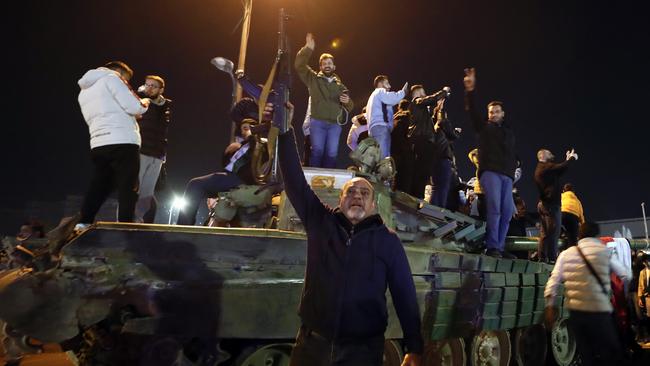 Syrians celebrate the arrival of opposition fighters in Damascus, Syria. Picture: Omar Sanadiki